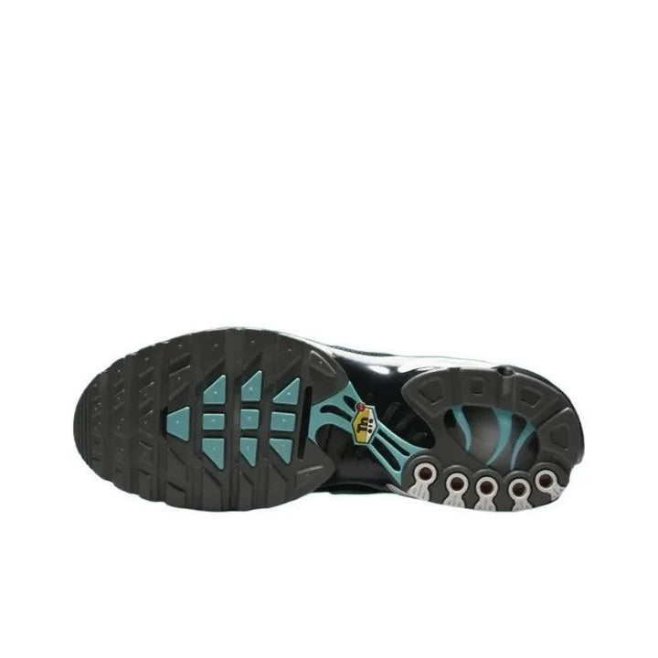 Sole of black athletic sneakers with teal accents and rugged tread pattern.