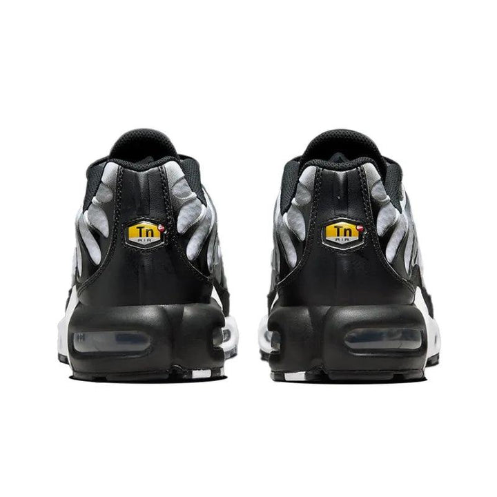 Rear view of black and silver athletic sneakers with air cushioning soles.