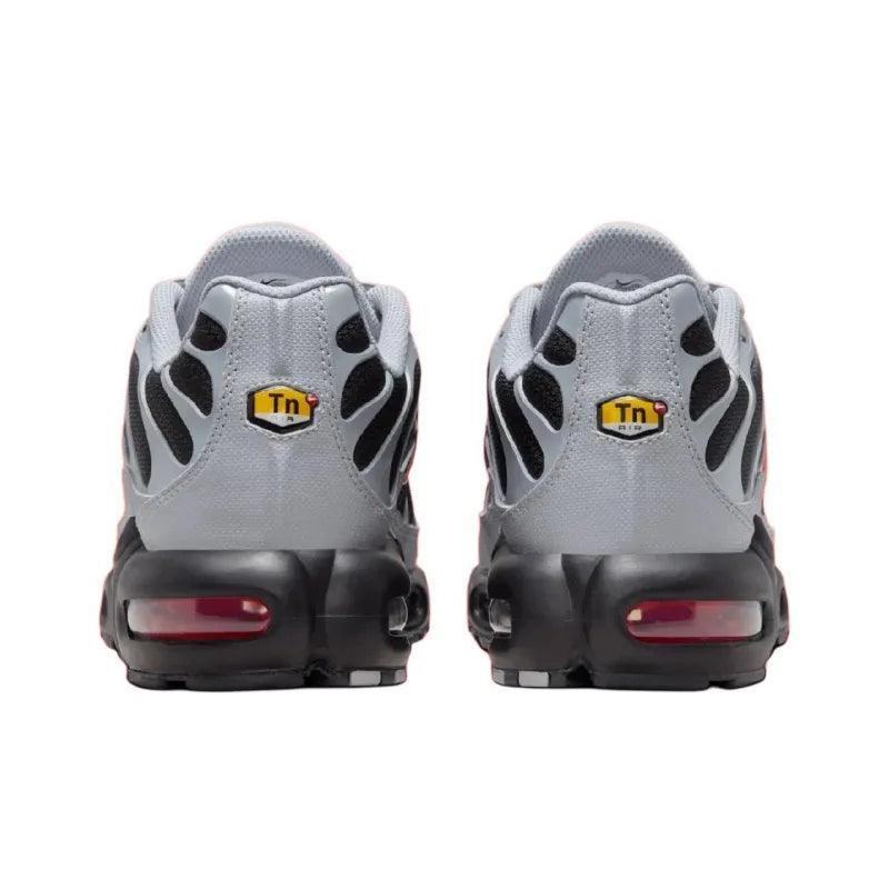 Rear view of grey and black athletic running sneakers with air cushioning soles.