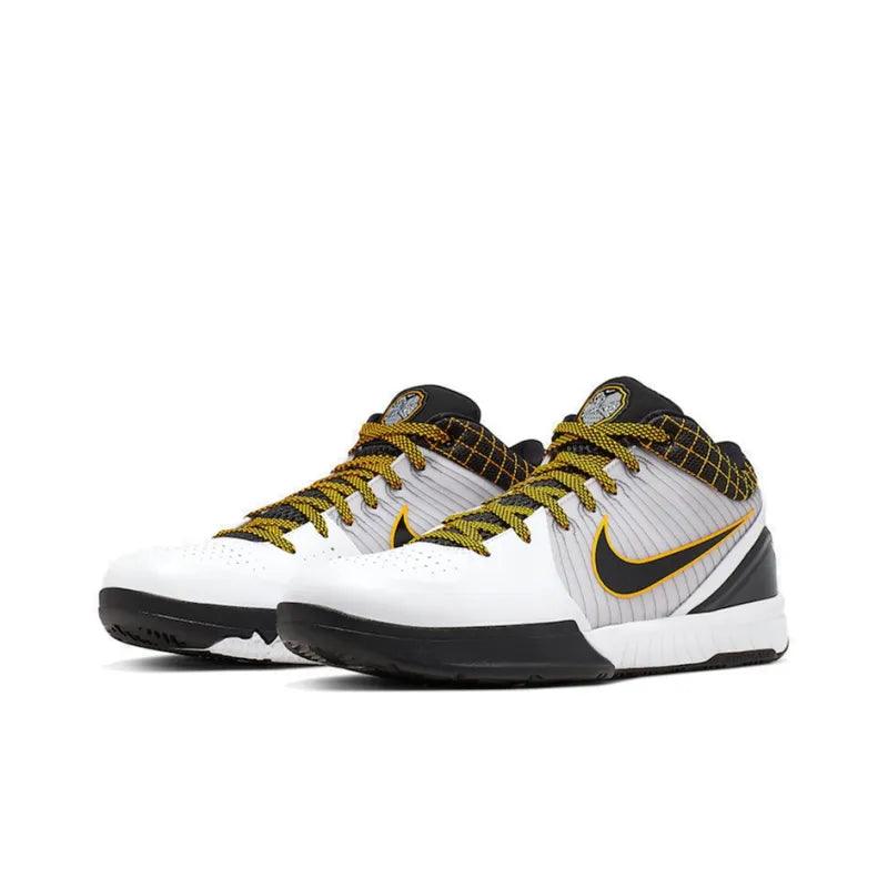 Pair of white and black Nike training shoes with yellow laces and a gold swoosh.