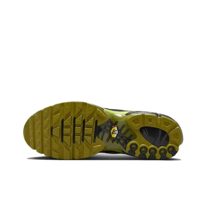 Sole of a green and black athletic sneaker with a textured traction pattern.