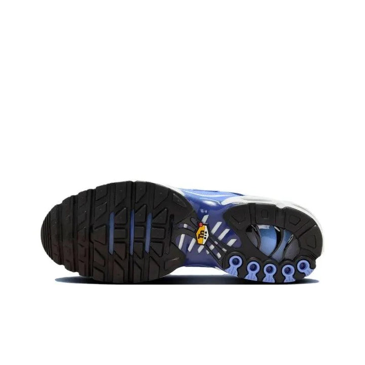 Sole view of a blue and black athletic sneaker with a textured rubber grip.