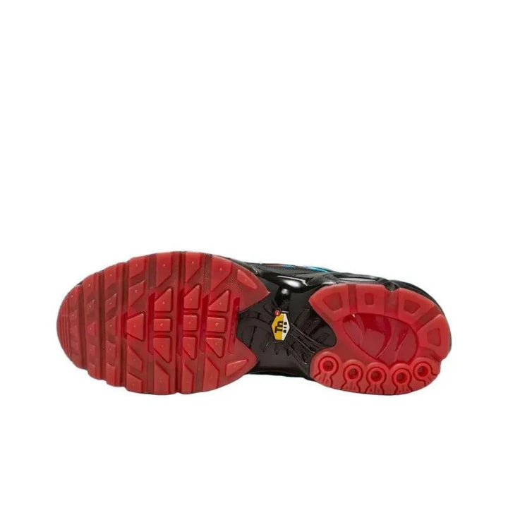 Sole of a black and red athletic sneaker with a textured grip pattern.