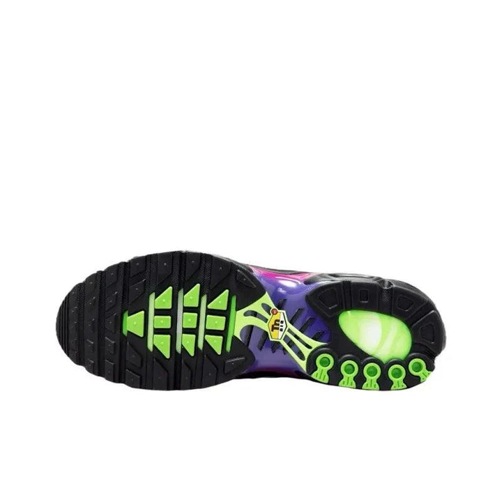 Sole of a colorful athletic sneaker with black tread and bright green accents.