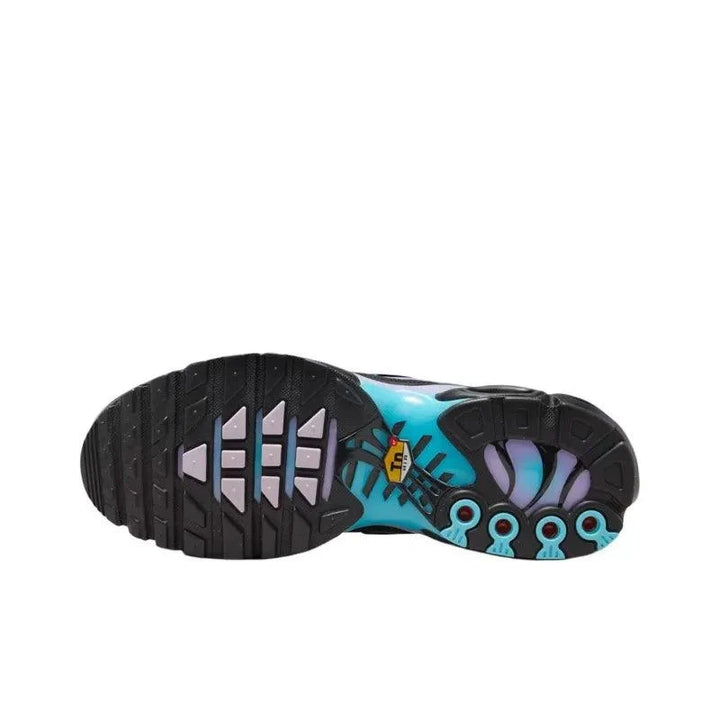 Sole view of a colorful patterned athletic sneaker with black tread and blue accents.