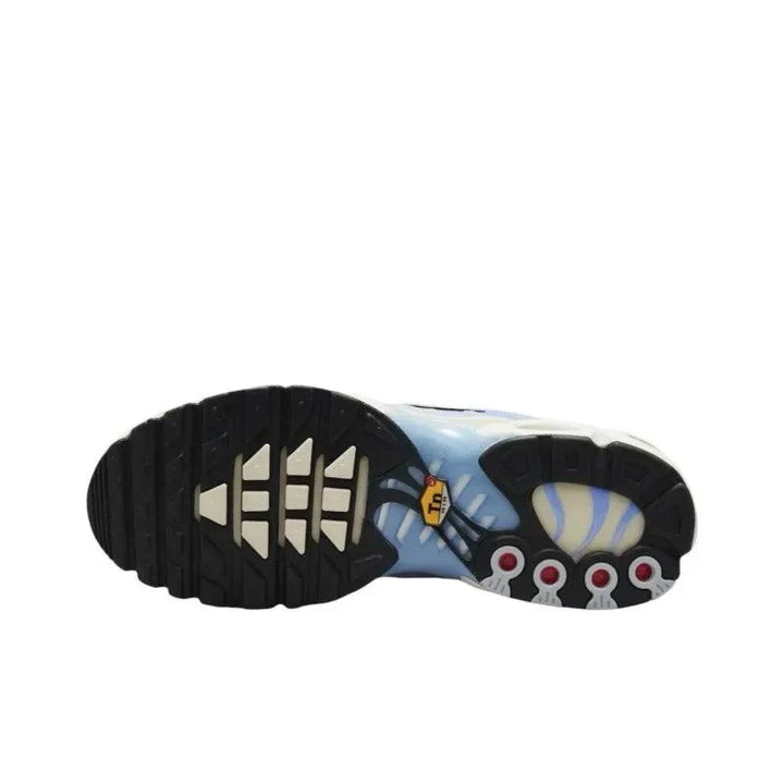 Sole of a white and light blue patterned sneaker with black tread and red accents.