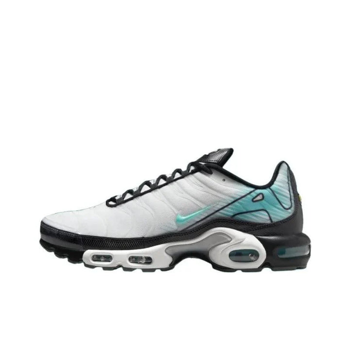 White and black Nike Air Max Plus sneakers with teal accents and air cushioning.