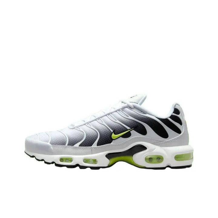 White and black athletic sneakers with neon green accents and air cushion sole