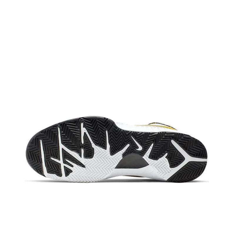 Sole of a white and black athletic tennis shoe with a durable patterned grip.
