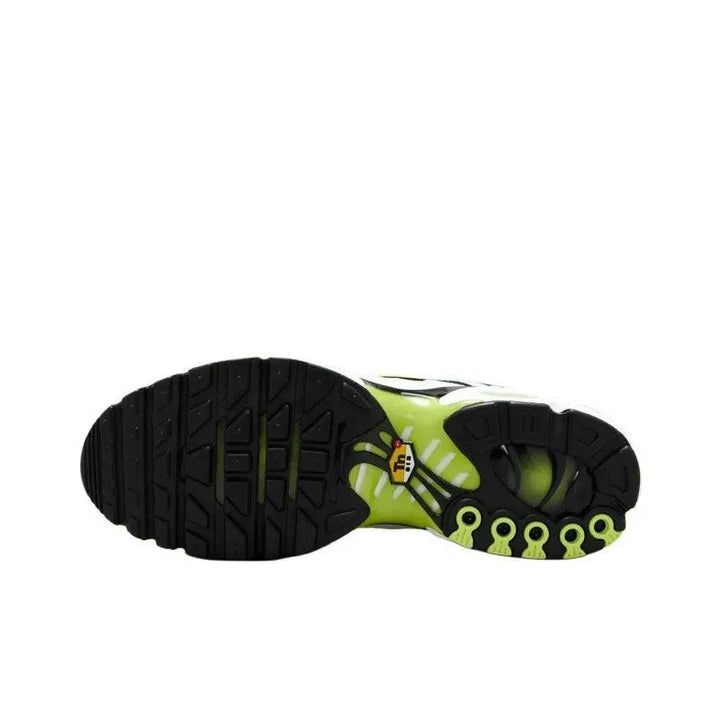 Sole of a sporty sneaker featuring a black treaded outsole and lime green accents.