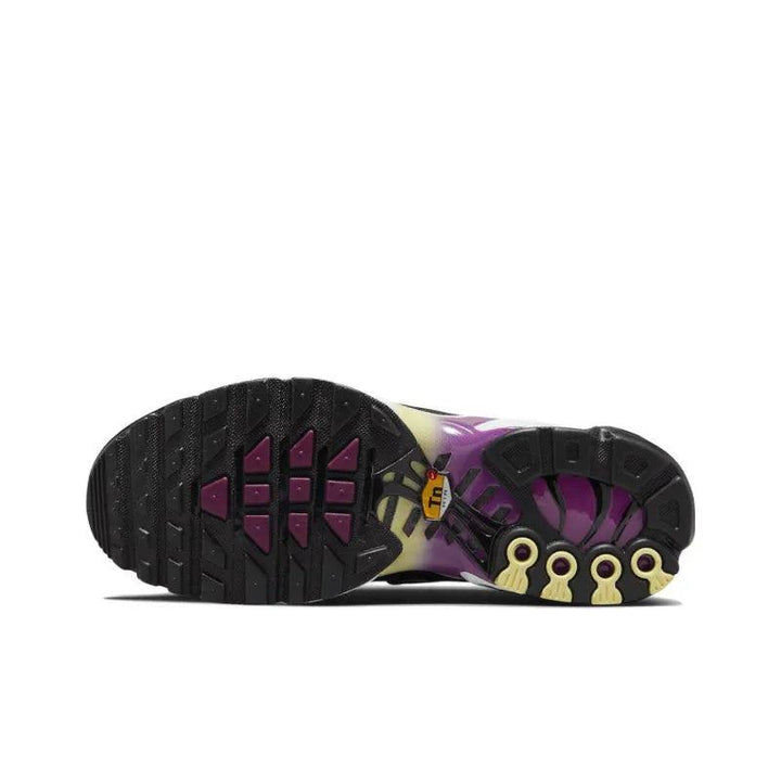 Sole view of a purple and black athletic sneaker with a textured rubber grip.