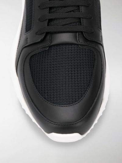 Fendi jacquard FF motif running sneakers styled with athletic gear for a trendy look.